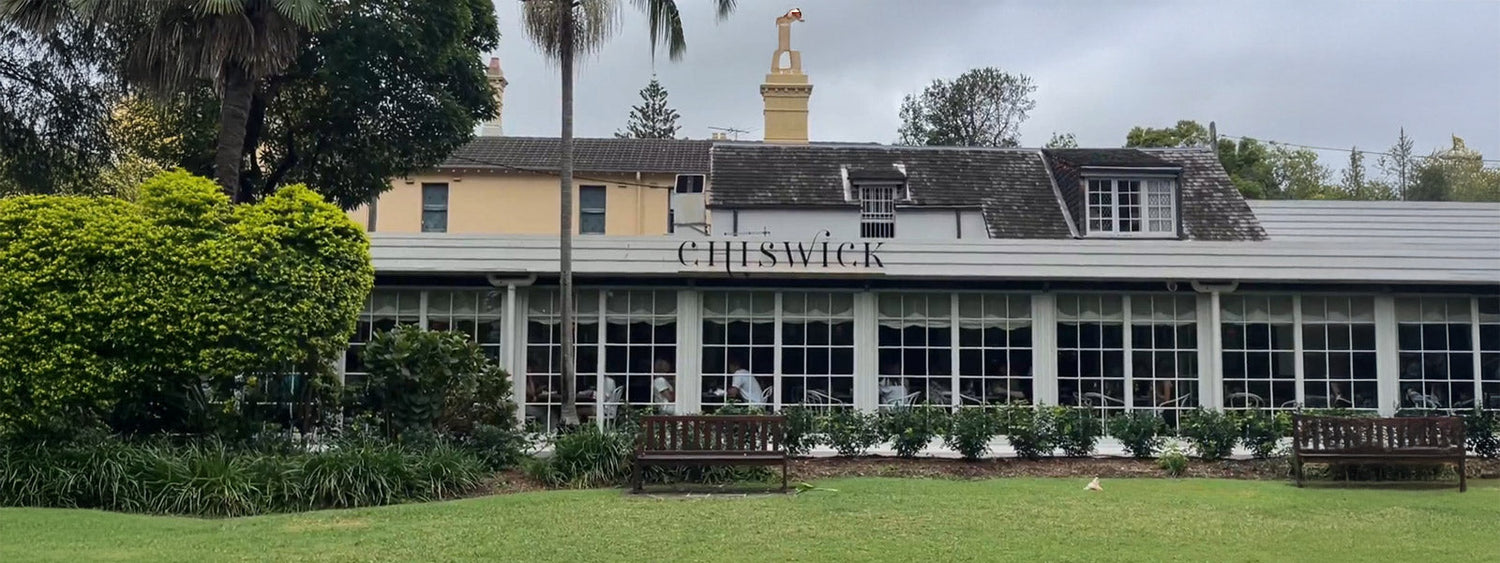Exterior of Chiswick Woollahra restaurant with manicured lawn, outdoor garden, and heritage-style facade.