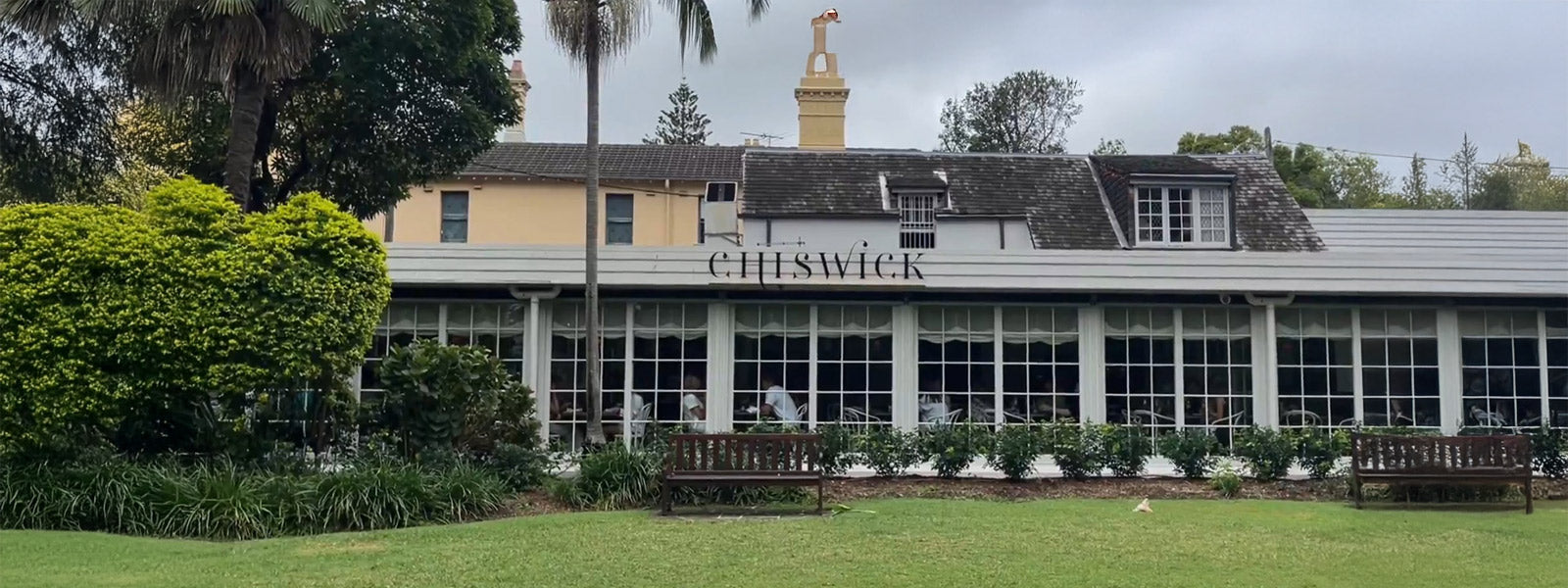 Exterior of Chiswick Woollahra restaurant with manicured lawn, outdoor garden, and heritage-style facade.